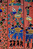 Wat Xieng Thong temple in Luang Prabang, Laos. the Ho Tai, the library. Colourful glass mosaics on a pink background with scenes of daily life. 